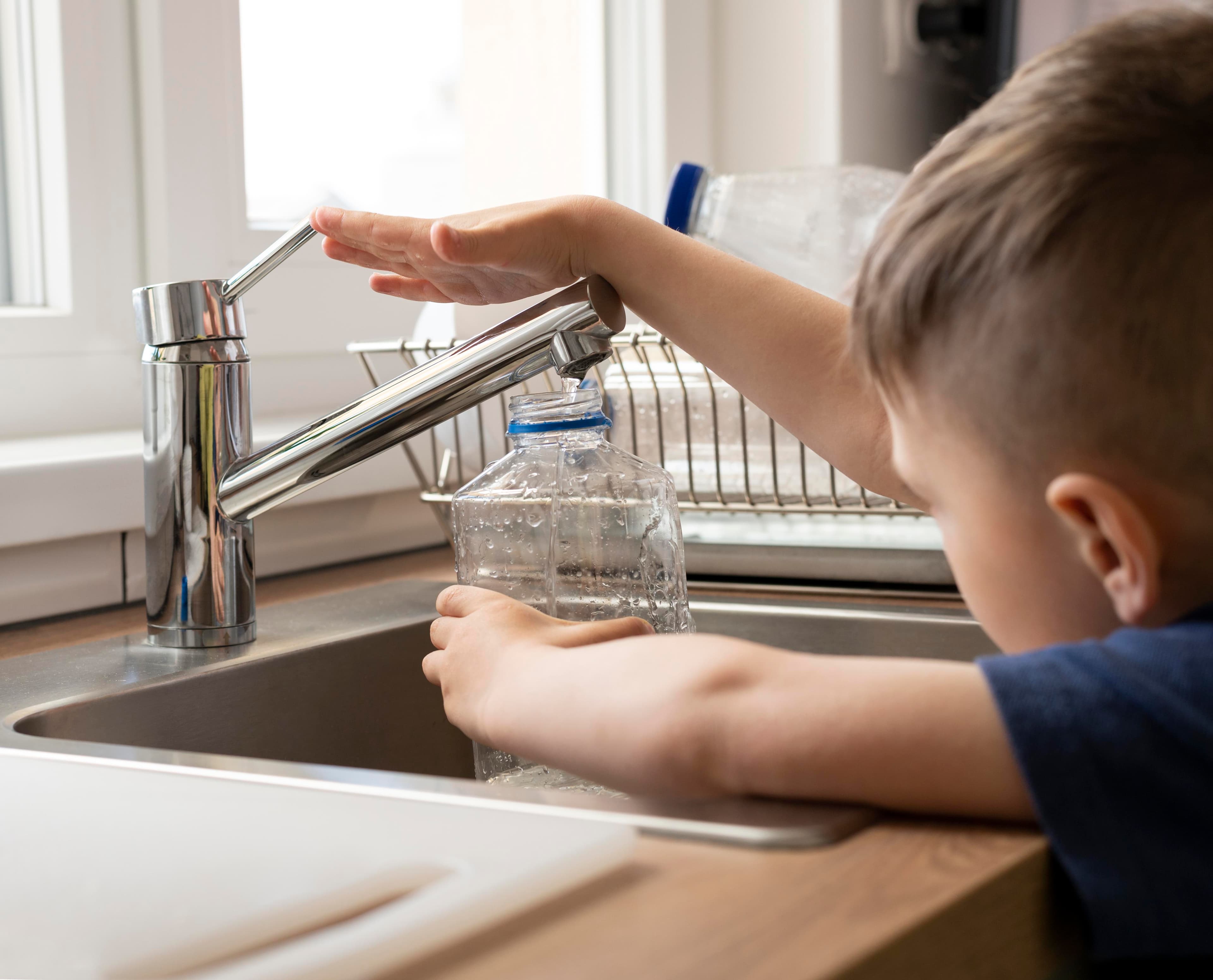 Child filling water bottle